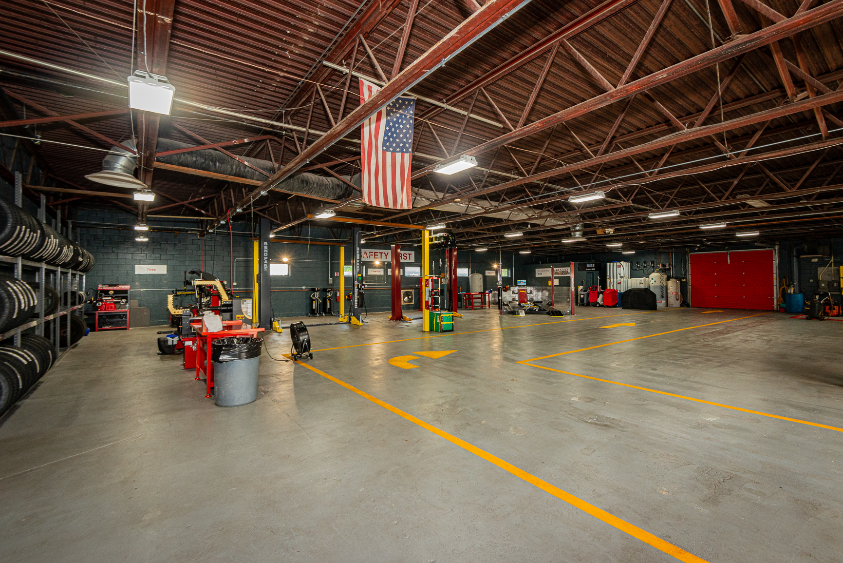 Service bays and lifts inside Commonwealth Automotive Center in Milford, NH