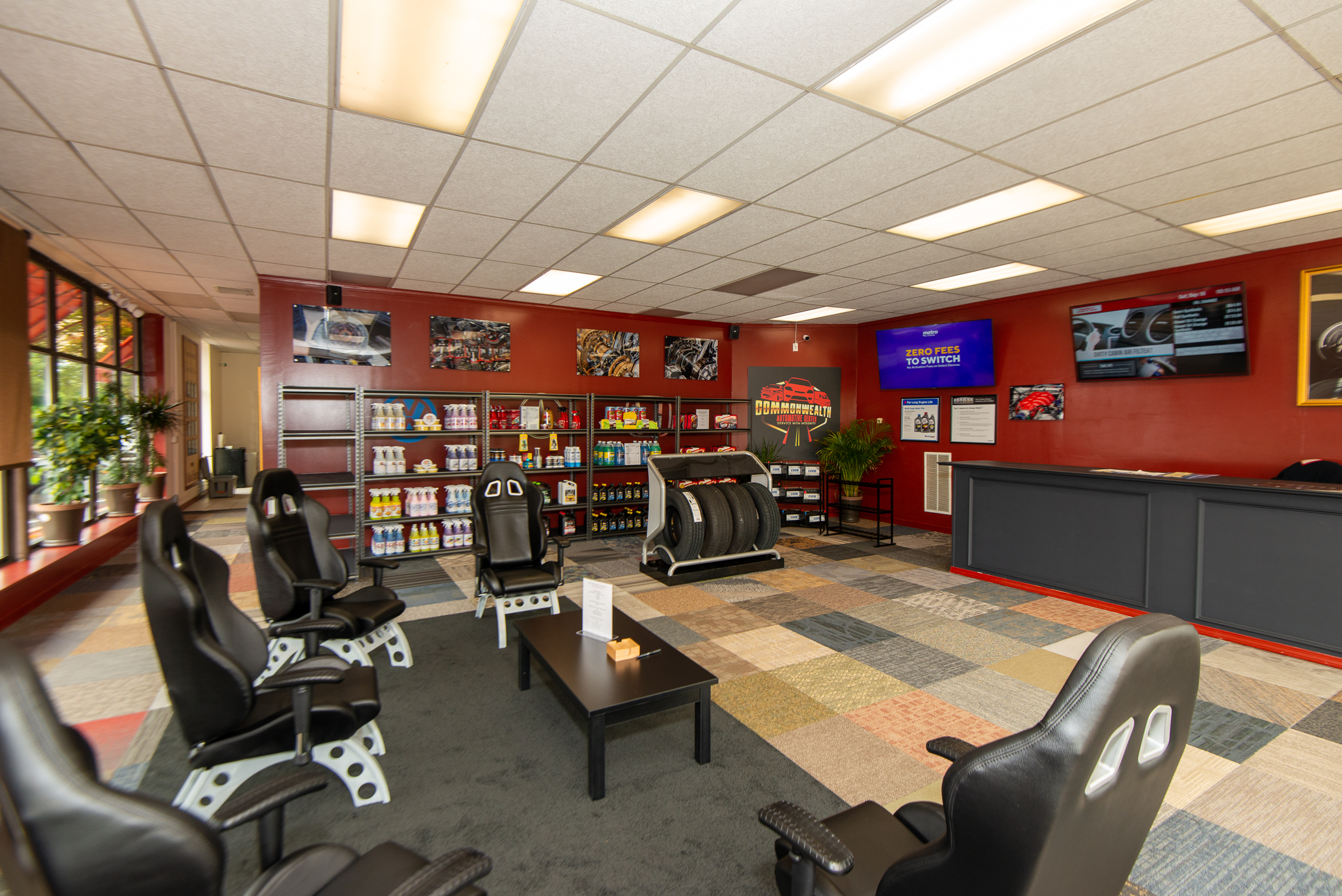 Customer waiting lounge with seating and televisions